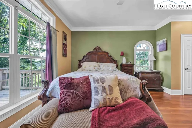 a living room with furniture a large window and a chandelier