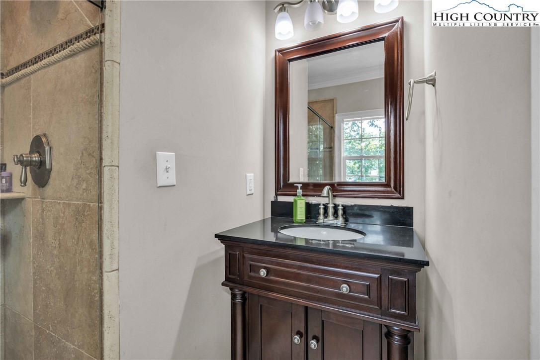 127 Deerfield Road West Jefferson, NC 28694 - Photo 26 of 47 a bathroom with a granite countertop sink and a mirror