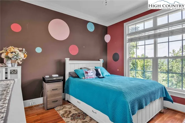 a view of a garden with lawn chairs under an umbrella