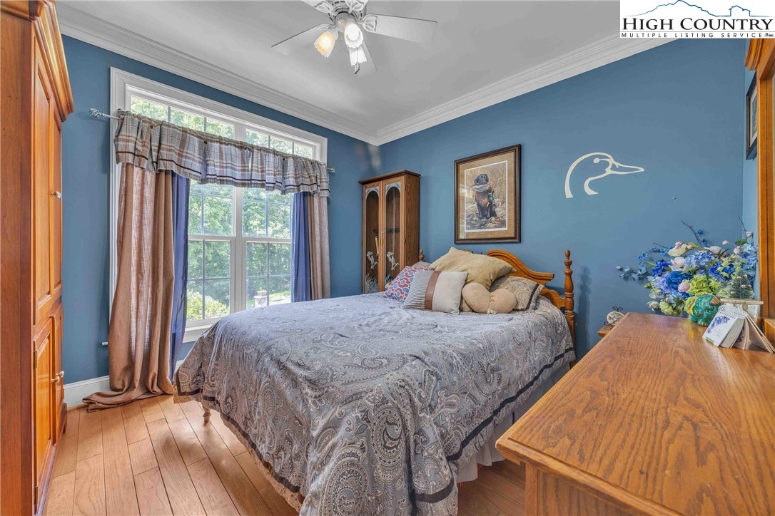 127 Deerfield Road West Jefferson, NC 28694 - Photo 28 of 47 a bedroom with a bed and a chandelier