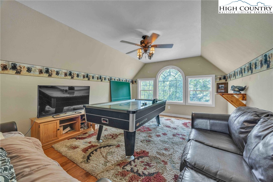 127 Deerfield Road West Jefferson, NC 28694 - Photo 30 of 47 a living room with furniture a fireplace and a chandelier