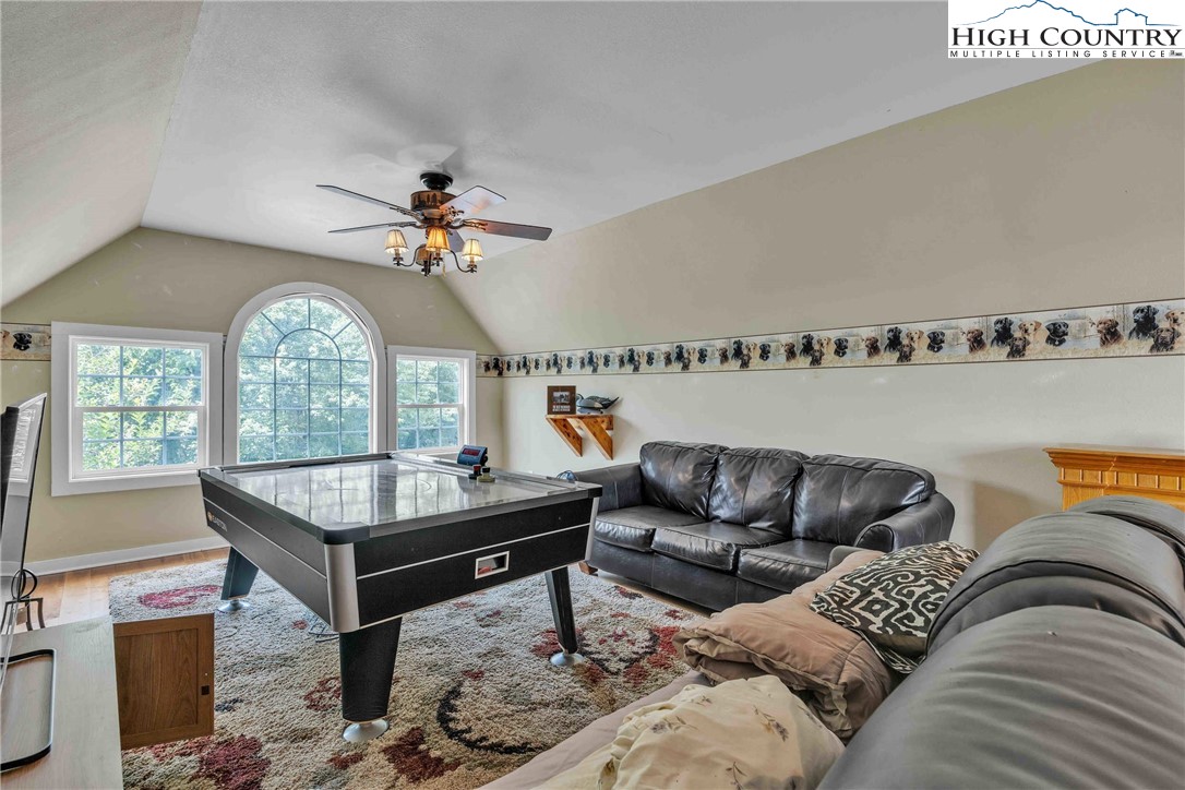 127 Deerfield Road West Jefferson, NC 28694 - Photo 31 of 47 a living room with furniture a large window and a chandelier
