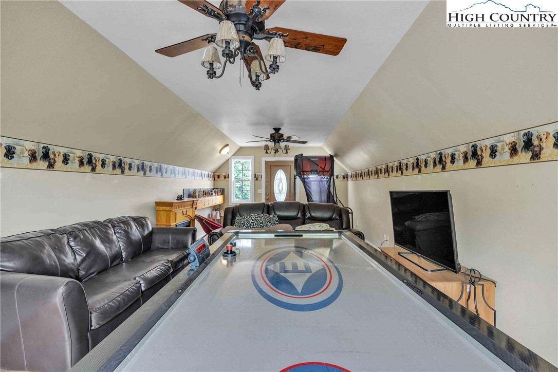 127 Deerfield Road West Jefferson, NC 28694 - Photo 32 of 47 a living room with furniture and a chandelier