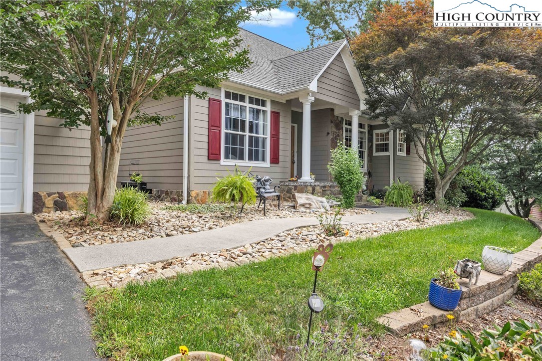 127 Deerfield Road West Jefferson, NC 28694 - Photo 6 of 47 a front view of a house with a yard and porch