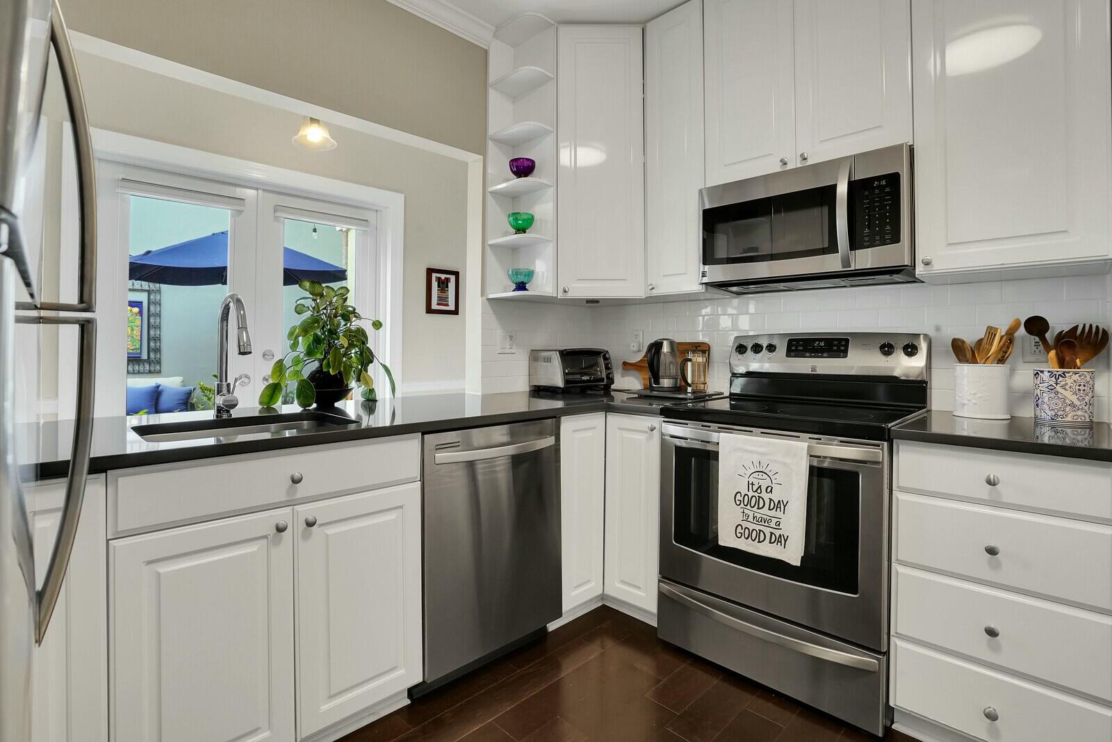 5961 Catesby Street Boca Raton, FL 33433 - Photo 13 of 41 a kitchen with white cabinets stainless steel appliances and sink