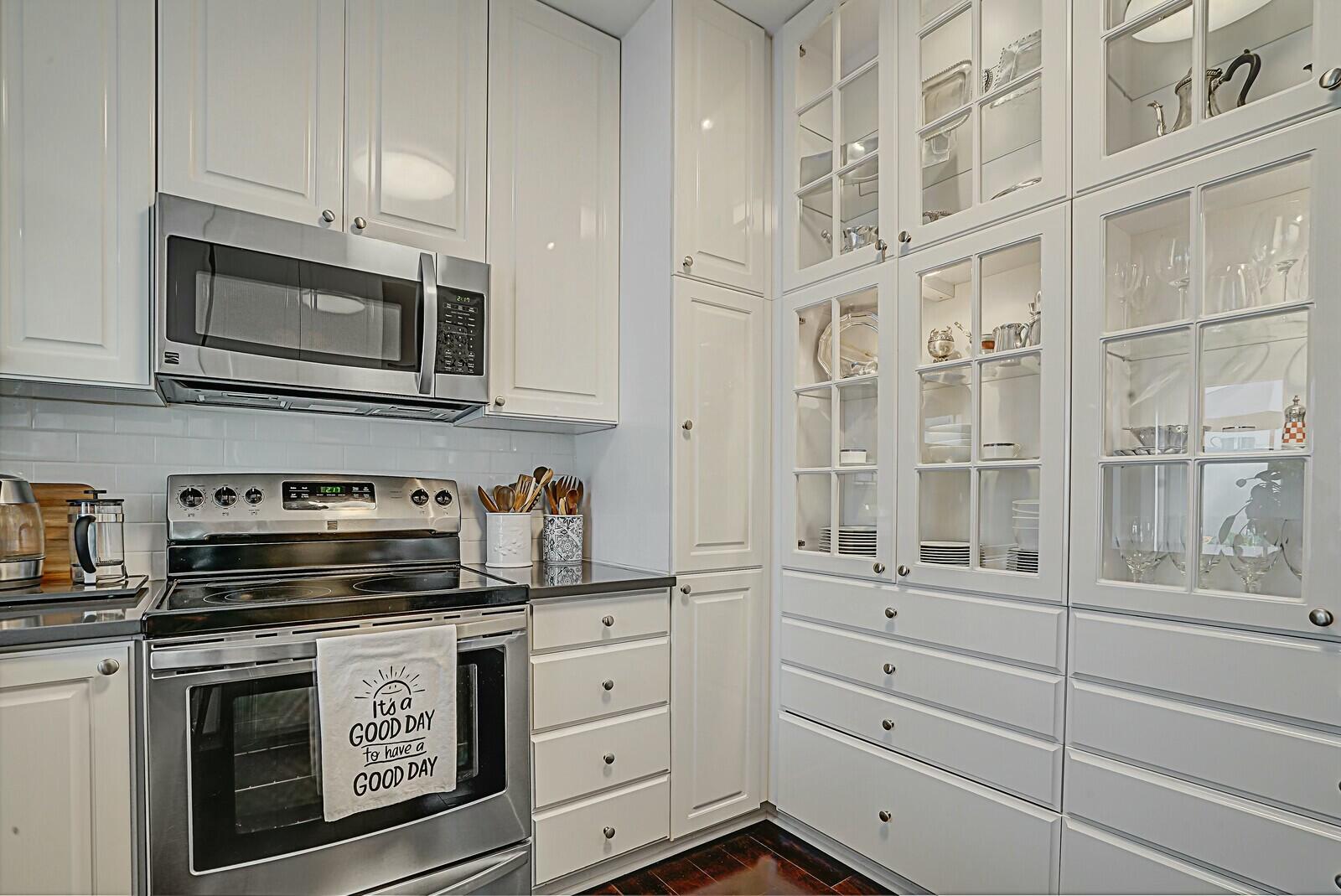 5961 Catesby Street Boca Raton, FL 33433 - Photo 15 of 41 a kitchen with stainless steel appliances granite countertop a stove microwave and cabinets