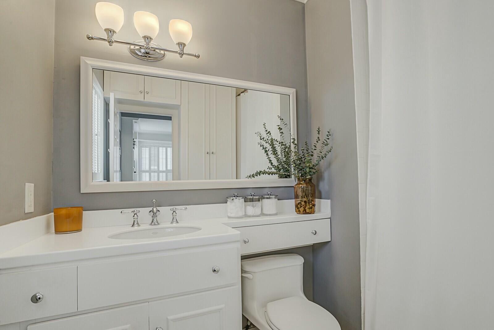 5961 Catesby Street Boca Raton, FL 33433 - Photo 18 of 41 a bathroom with a toilet sink and mirror