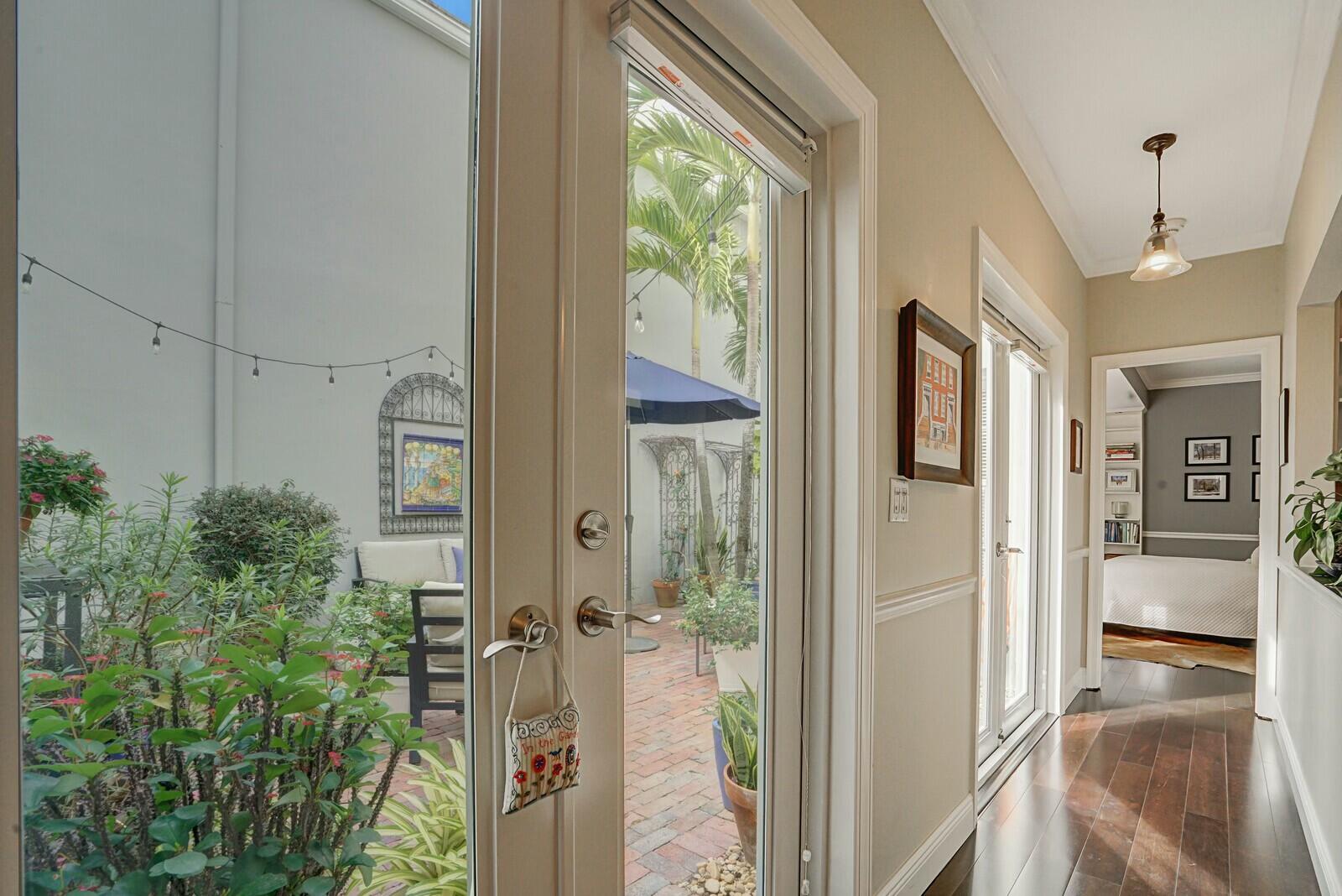 5961 Catesby Street Boca Raton, FL 33433 - Photo 19 of 41 a view of a hallway with a livingroom and dinning room with windows