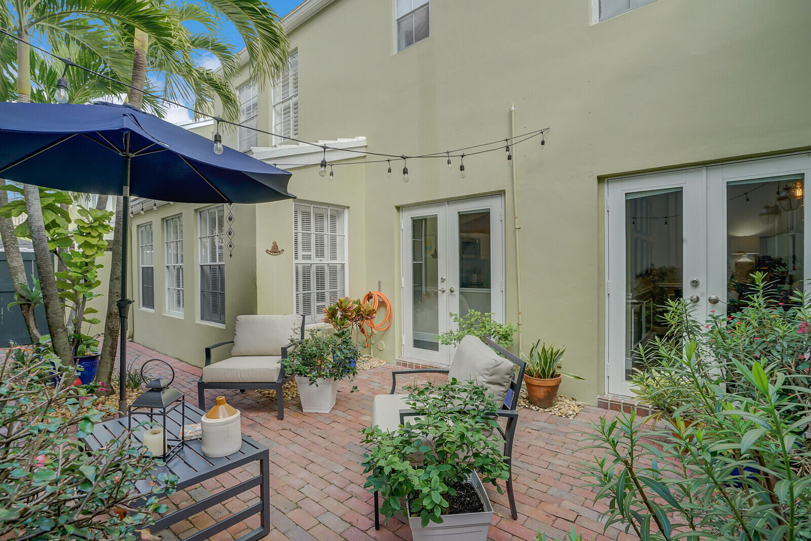 5961 Catesby Street Boca Raton, FL 33433 - Photo 22 of 41 a view of a chair and tables in the patio in front of house