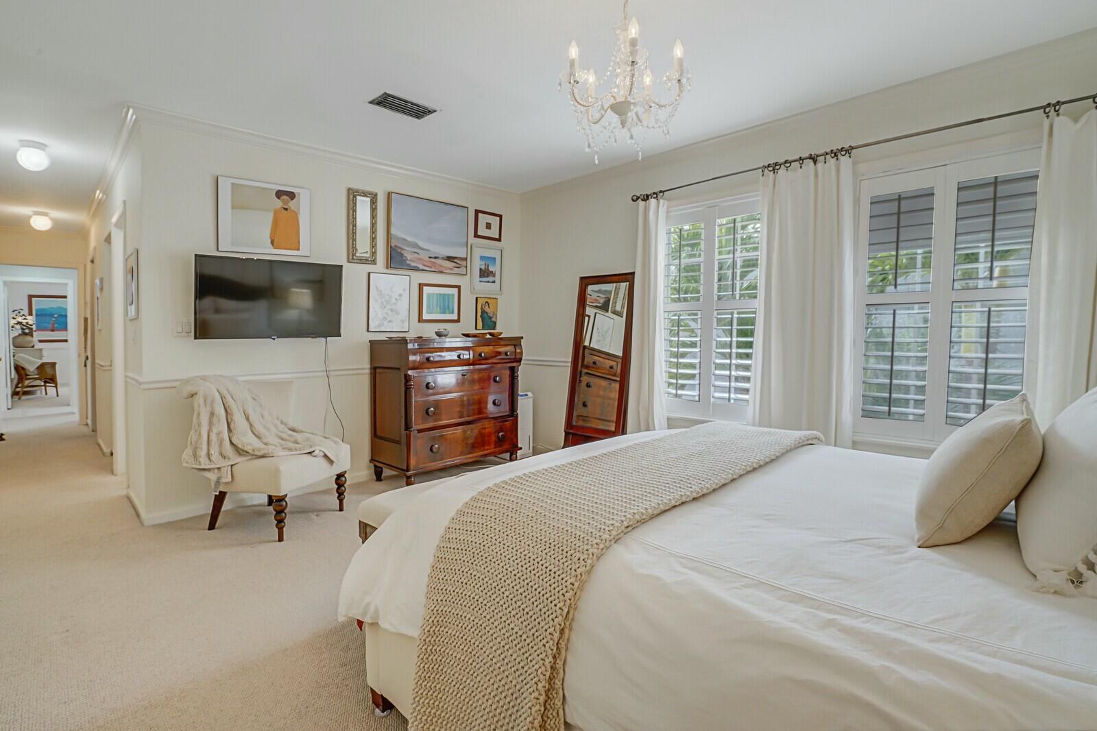 5961 Catesby Street Boca Raton, FL 33433 - Photo 26 of 41 a bedroom with a bed and furniture with large windows