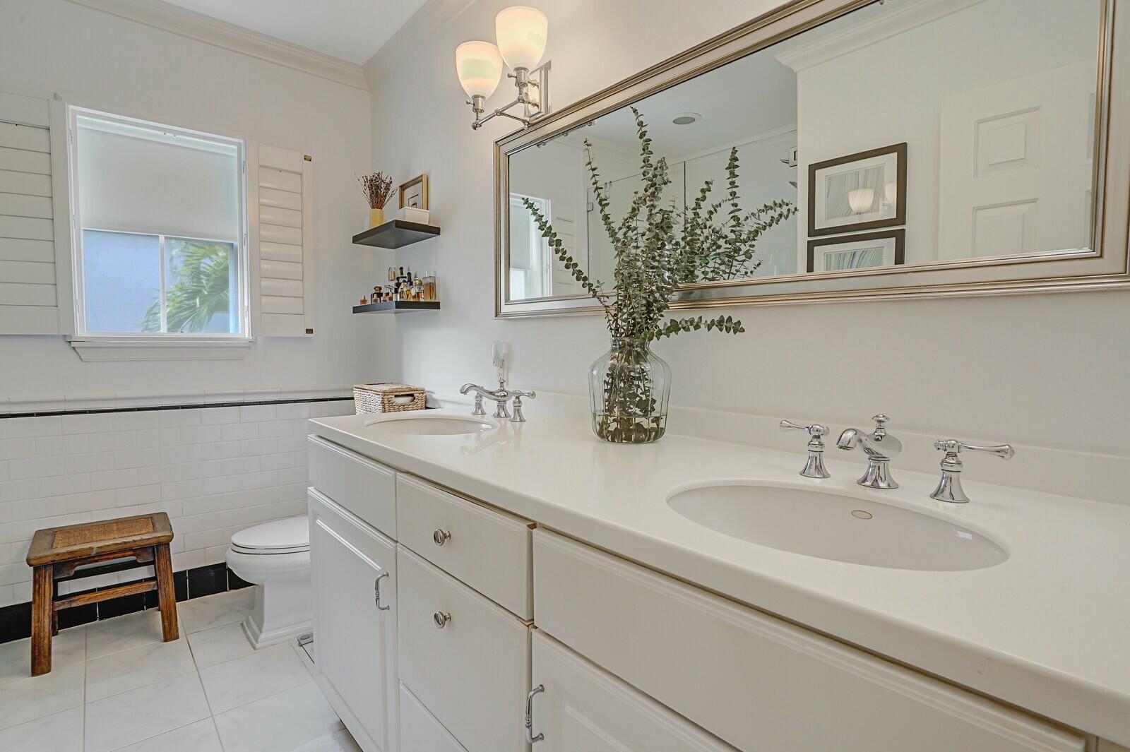 5961 Catesby Street Boca Raton, FL 33433 - Photo 30 of 41 a bathroom with a toilet sink and mirror