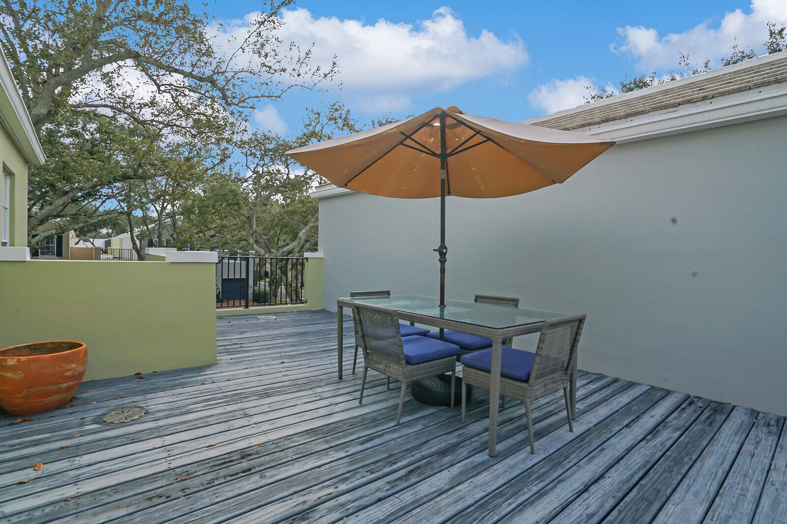 5961 Catesby Street Boca Raton, FL 33433 - Photo 33 of 41 a view of a roof deck with table and chairs under an umbrella