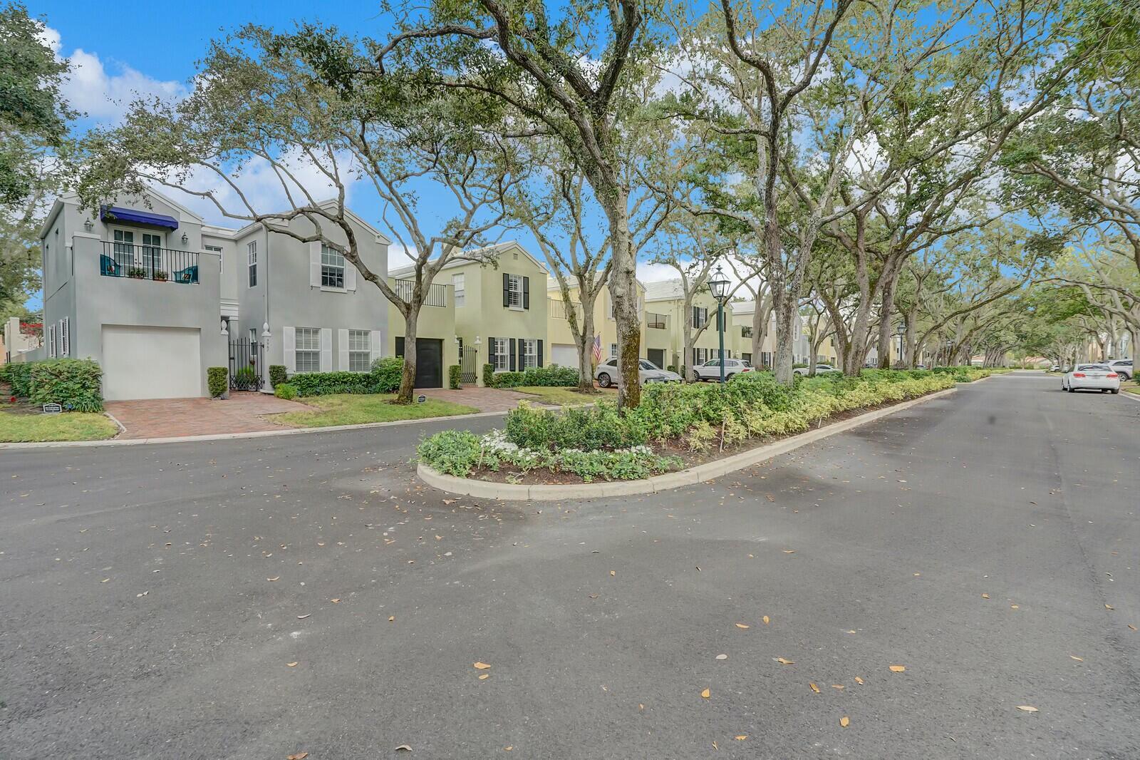 5961 Catesby Street Boca Raton, FL 33433 - Photo 37 of 41 a view of a white house with a big yard and large trees