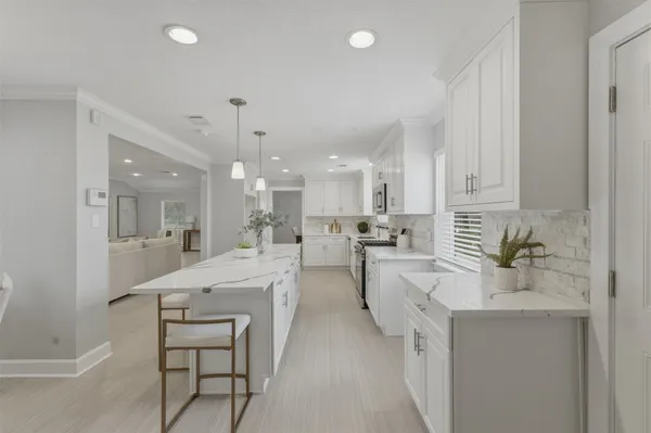 a spacious bedroom with a bed and a chandelier