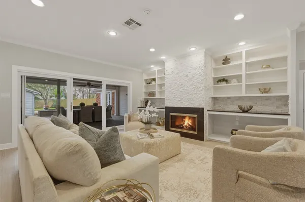 a kitchen with white cabinets and sink