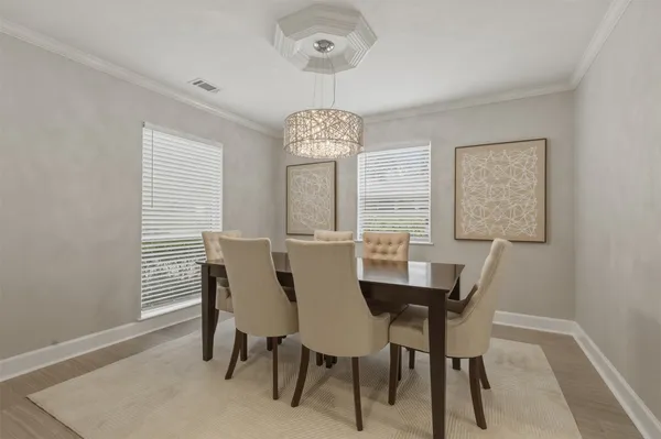 a large white kitchen with a lot of white furniture and appliances