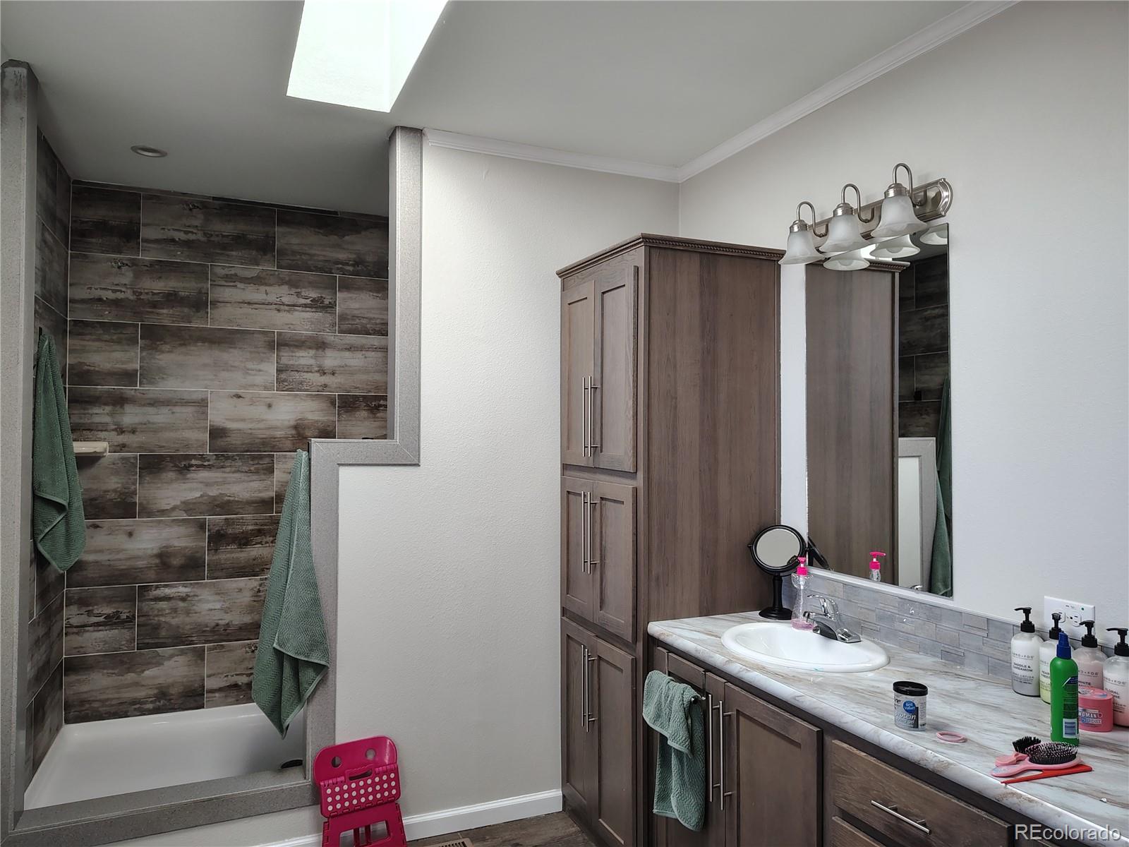15460 Casler Avenue Fort Lupton, CO 80621 - Photo 12 of 13 a bathroom with a sink and a mirror