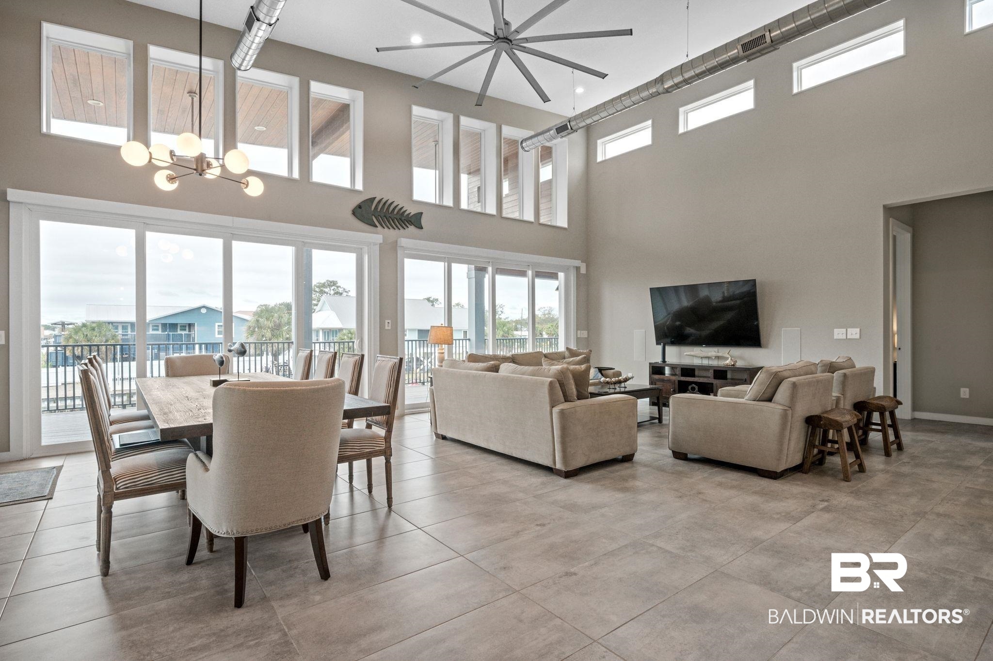 3840 Cotton Way Orange Beach, AL 36561 - Photo 2 of 75 Living room featuring a high ceiling and a notable chandelier
