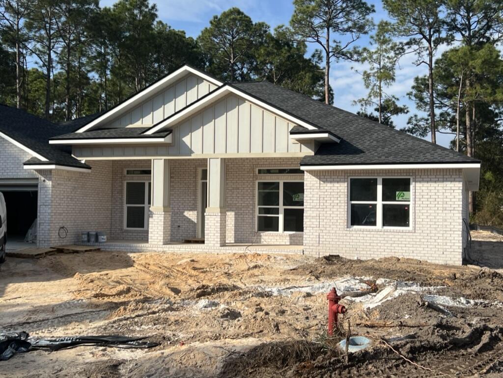 7586 Vinca Street Navarre, FL 32566 - Photo 2 of 44 a front view of a house with a yard