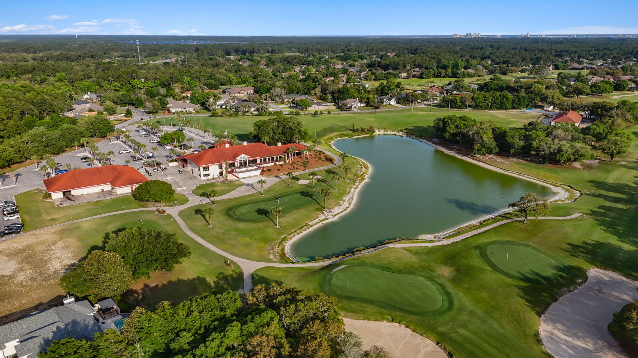 7586 Vinca Street Navarre, FL 32566 - Photo 42 of 44 an aerial view of a golf course with a lake view