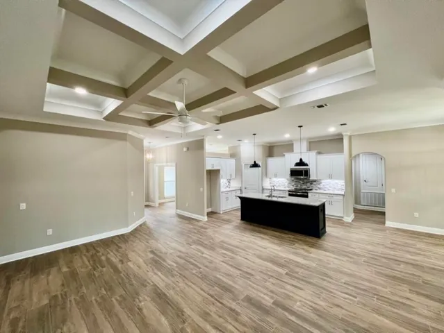 a view of a room with wooden floor