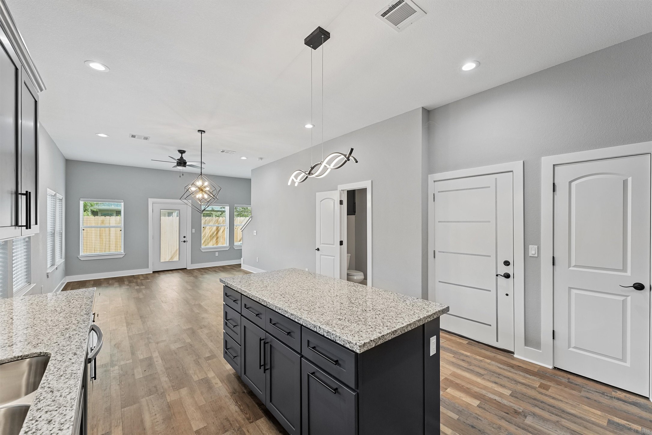 7704 Sealey Street Houston, TX 77088 - Photo 3 of 15 an empty room with wooden floor and windows