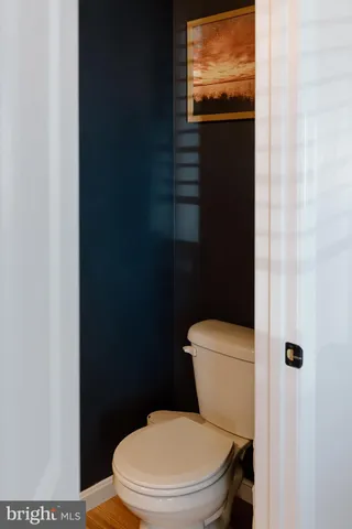 a white toilet sitting next to a shower curtain