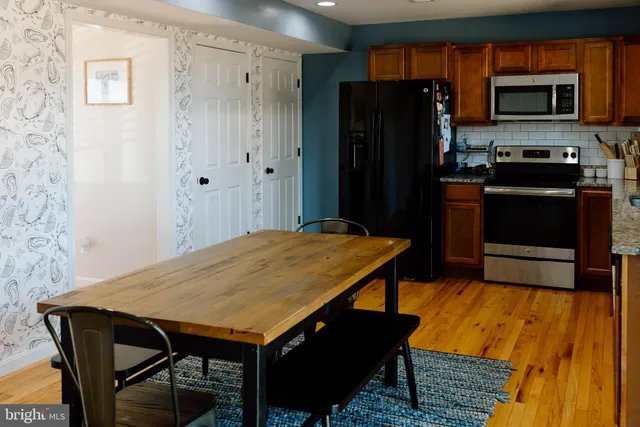 a kitchen with a table and refrigerator