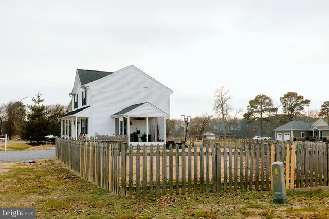 a view of a house with wooden fence