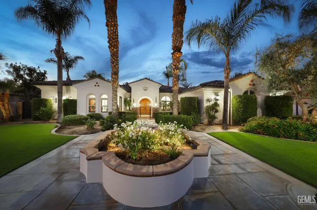 a view of a house with a yard and potted plants
