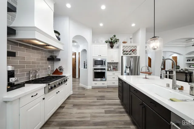 a large kitchen with a table and chairs