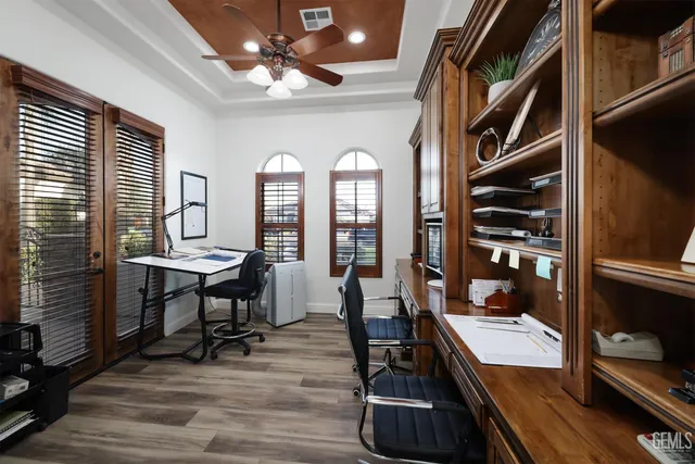 a spacious bathroom with a double vanity sink a mirror and a bathtub