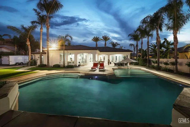 a view of swimming pool with outdoor seating and a patio