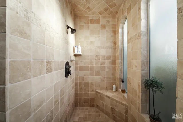 a spacious bedroom with a bed and a flat screen tv