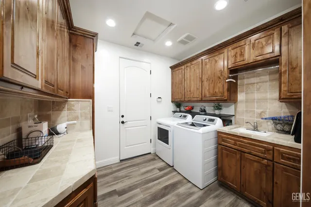 a view of a patio with dining table and chairs under a palm tree