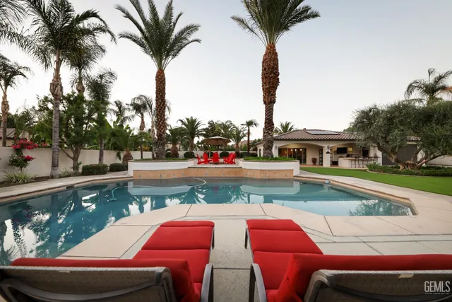 a bedroom with a large bed and a flat screen tv