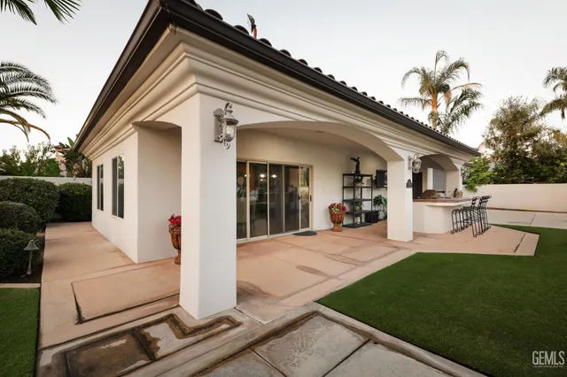 an aerial view of a house with a yard and lake view