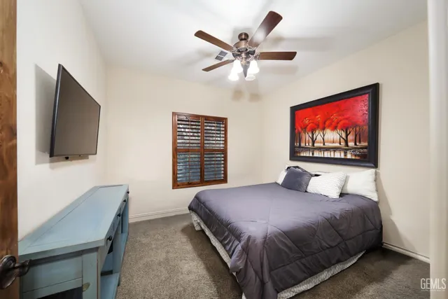 a front view of a house with a garden and trees