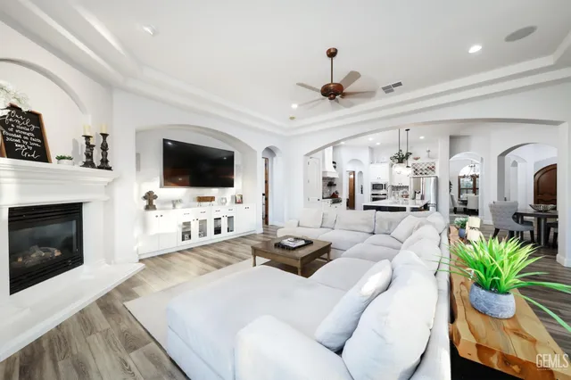 a kitchen with stainless steel appliances a table chairs stove and refrigerator