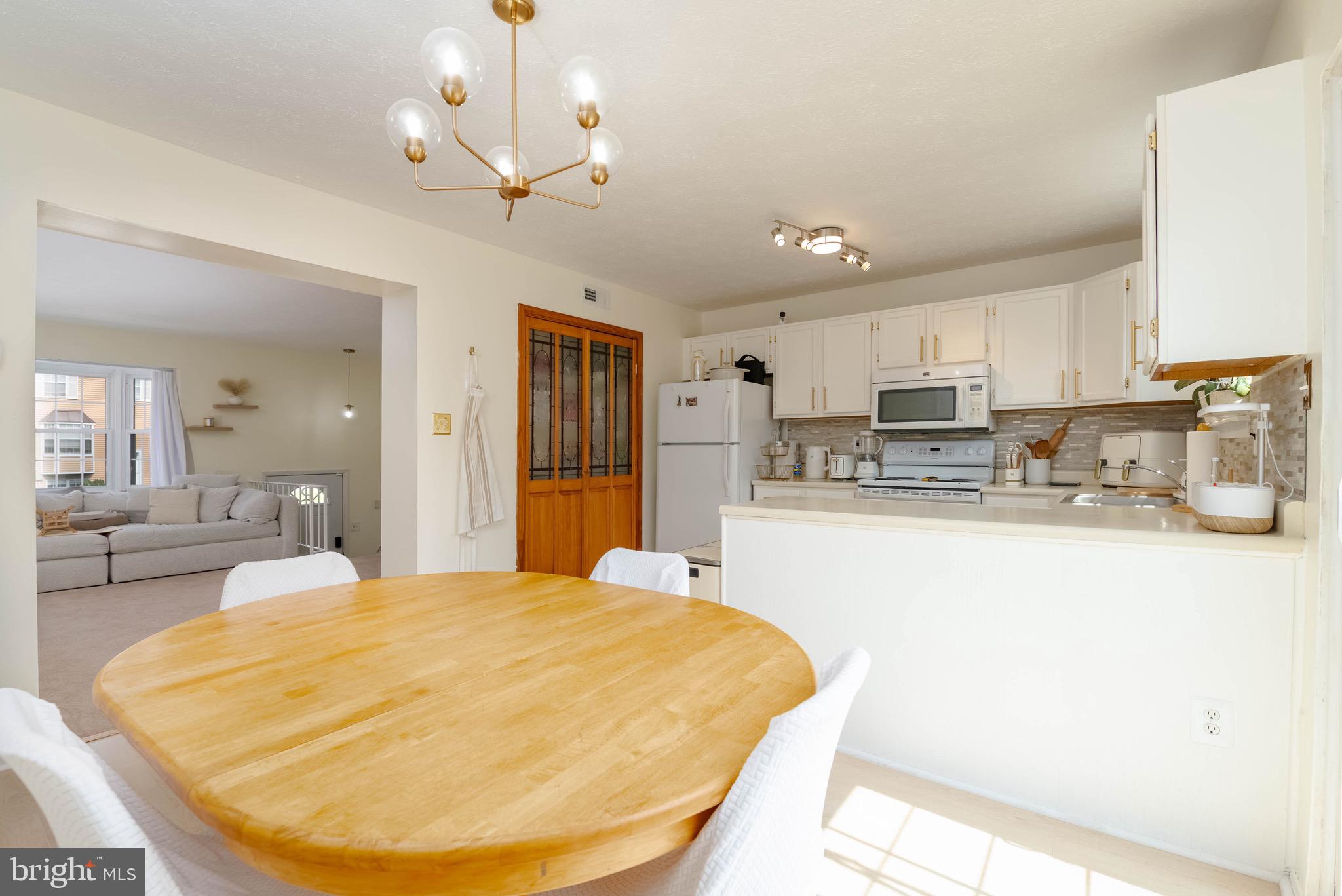 423 Kosoak Road Baltimore, MD 21220 - Photo 6 of 18 a bed room with a bed mirror and a kitchen view