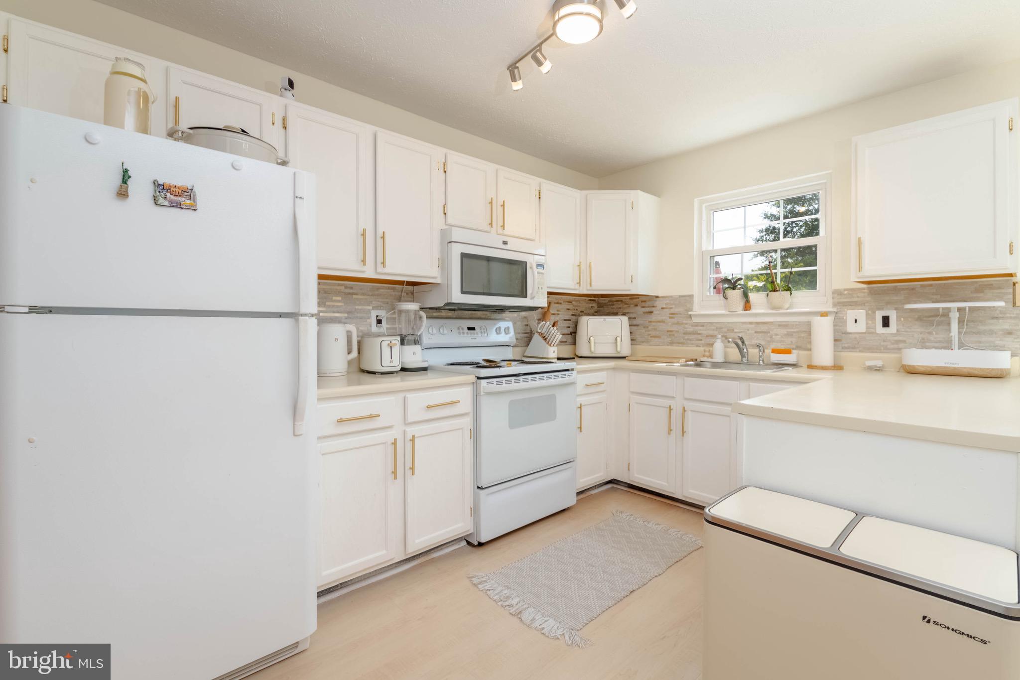 423 Kosoak Road Baltimore, MD 21220 - Photo 7 of 18 a kitchen with cabinets stainless steel appliances and a window