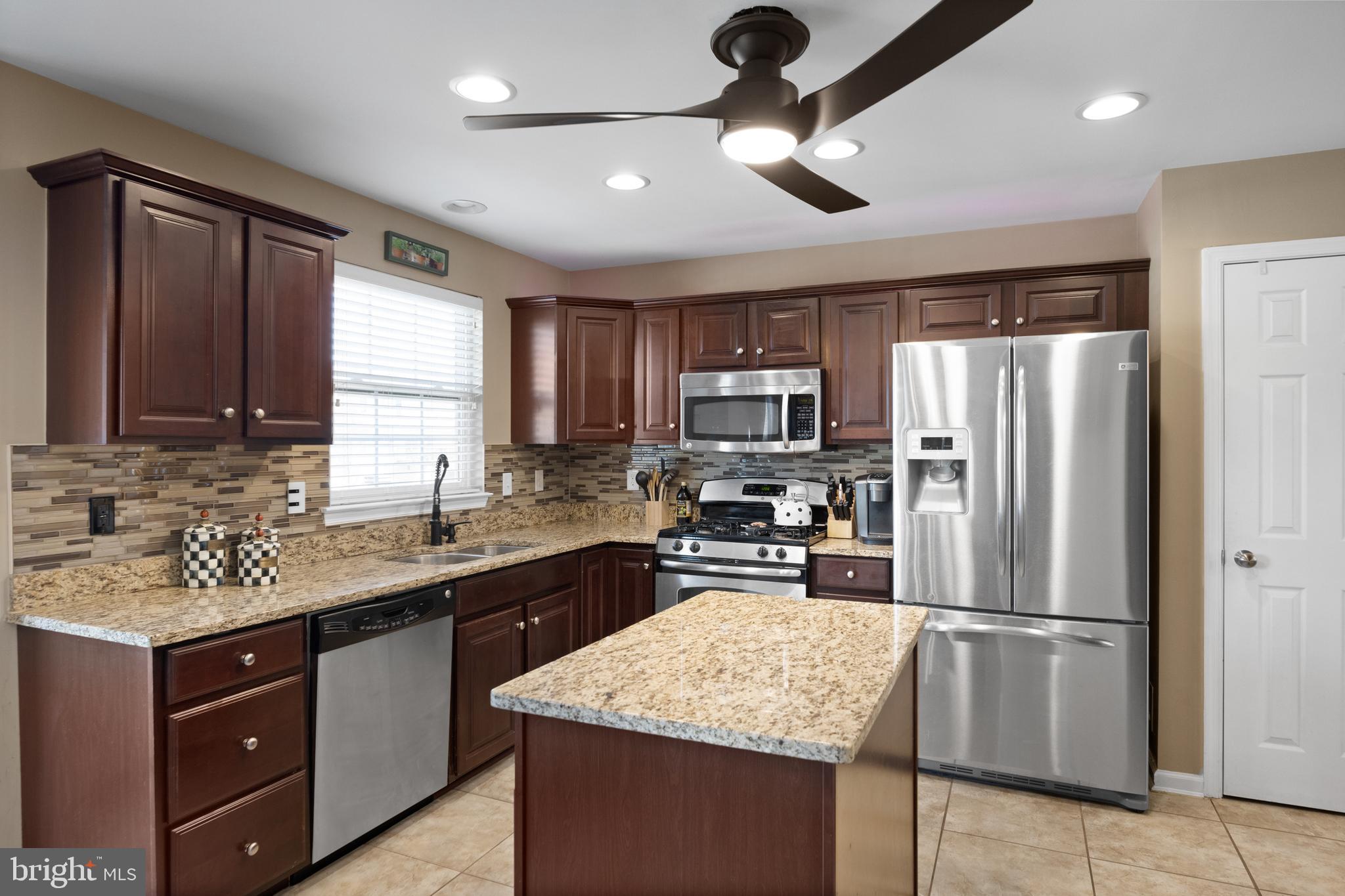 2 Tieman Circle Delanco, NJ 08075 - Photo 15 of 30 a kitchen with kitchen island granite countertop stainless steel appliances a sink stove refrigerator and cabinets