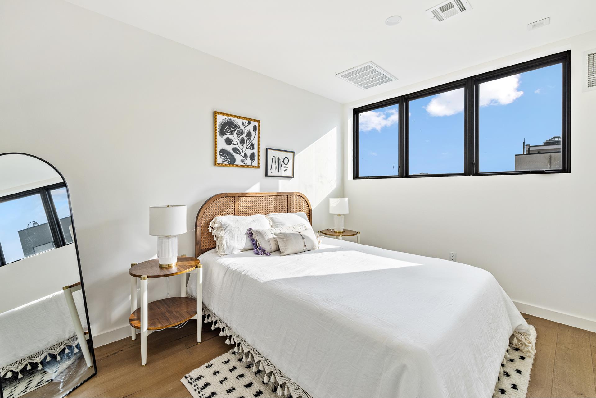 44 Box Street, Unit PHA Brooklyn, NY 11222 - Photo 10 of 18 a bedroom with a bed and a large mirror on the dresser