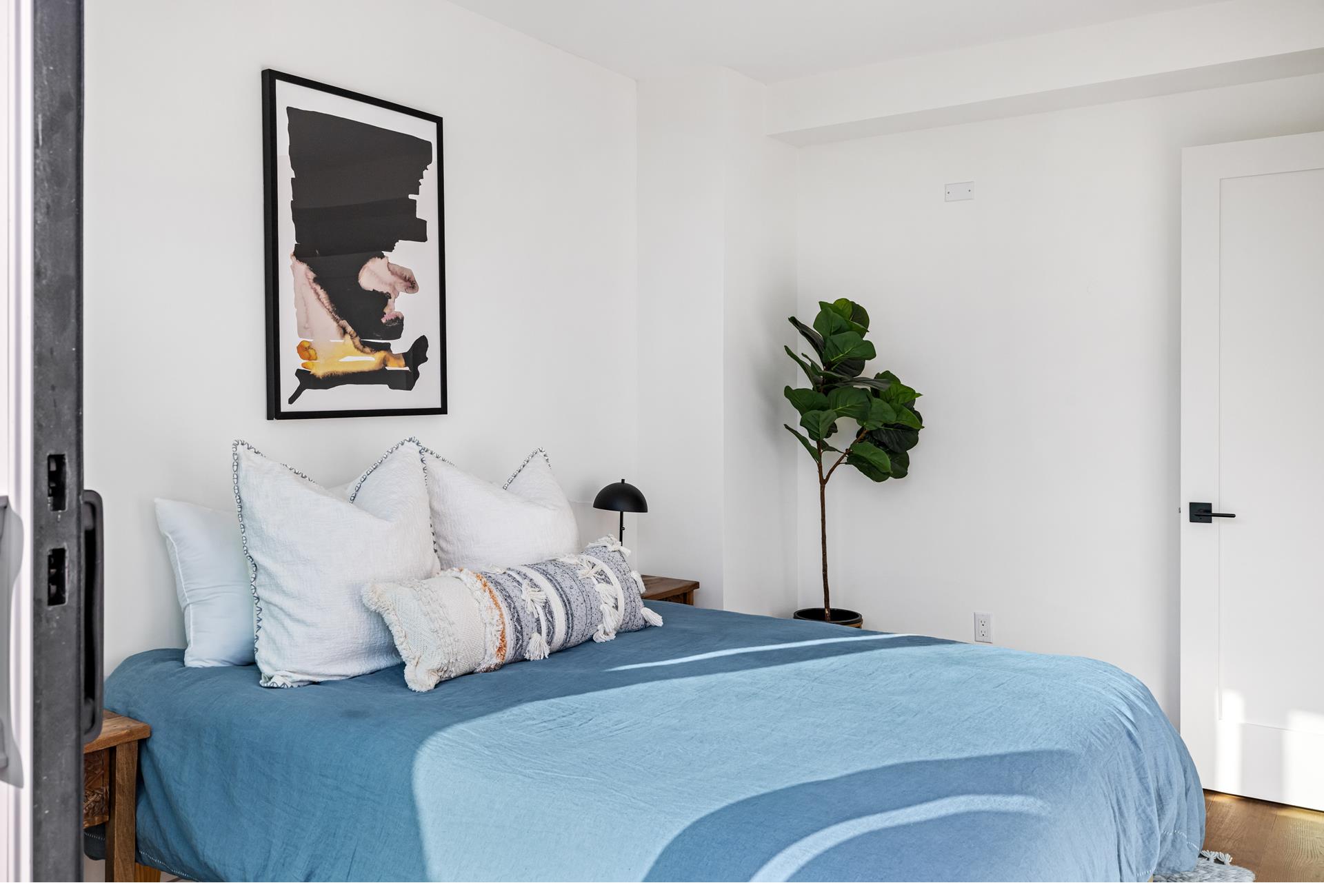 44 Box Street, Unit PHA Brooklyn, NY 11222 - Photo 11 of 18 a bedroom with bed and a potted plant