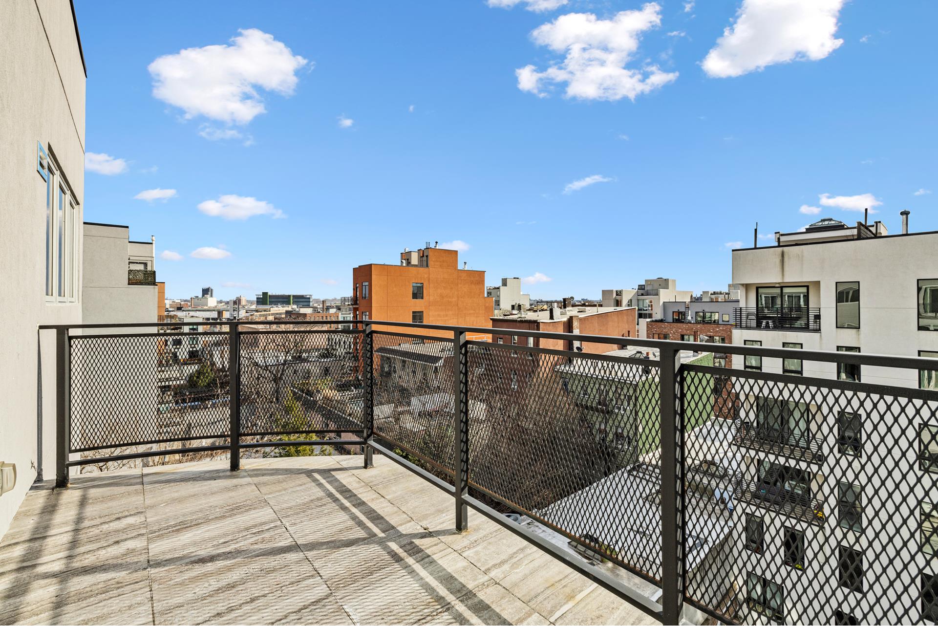 44 Box Street, Unit PHA Brooklyn, NY 11222 - Photo 13 of 18 a view of a balcony with a dinning table and chairs
