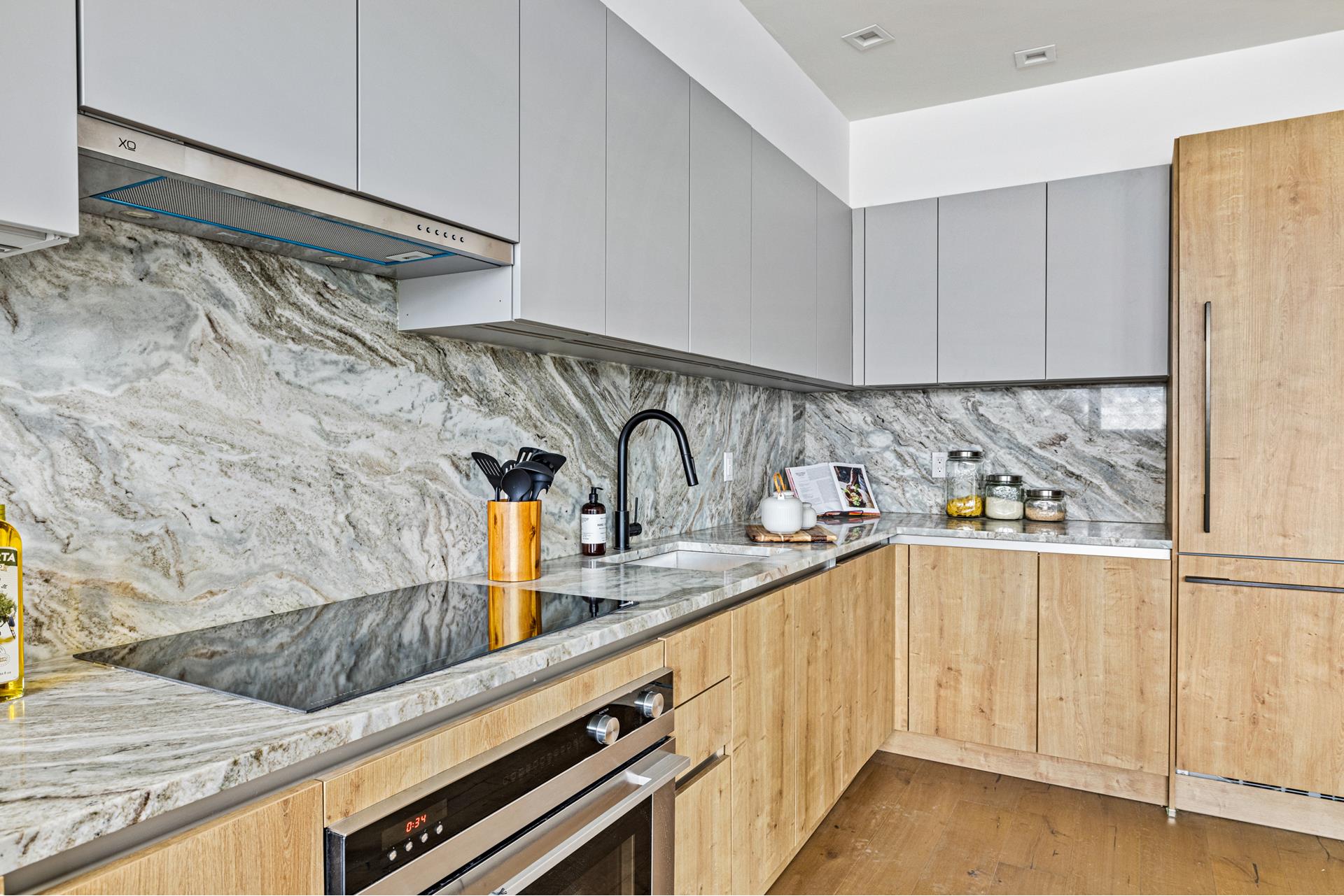 44 Box Street, Unit PHA Brooklyn, NY 11222 - Photo 6 of 18 a kitchen with granite countertop white cabinets and white appliances