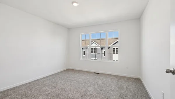 an empty room with a empty space and windows