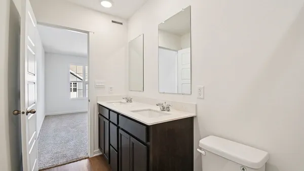 a bathroom with a sink toilet and mirror