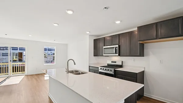 a kitchen with stainless steel appliances a stove microwave and cabinets