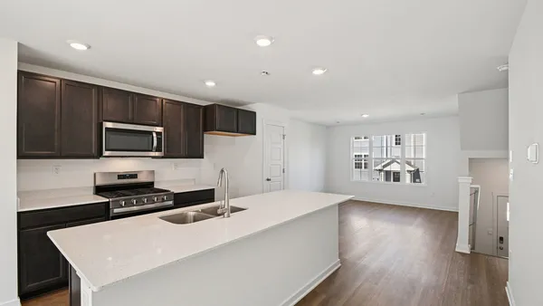 a kitchen with stainless steel appliances a refrigerator stove top oven and cabinets